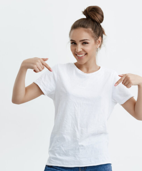 charming-emotive-caucasian-woman-pointing-down-her-t-shirt-while-smiling-joyfully-expressing-positive-emotions